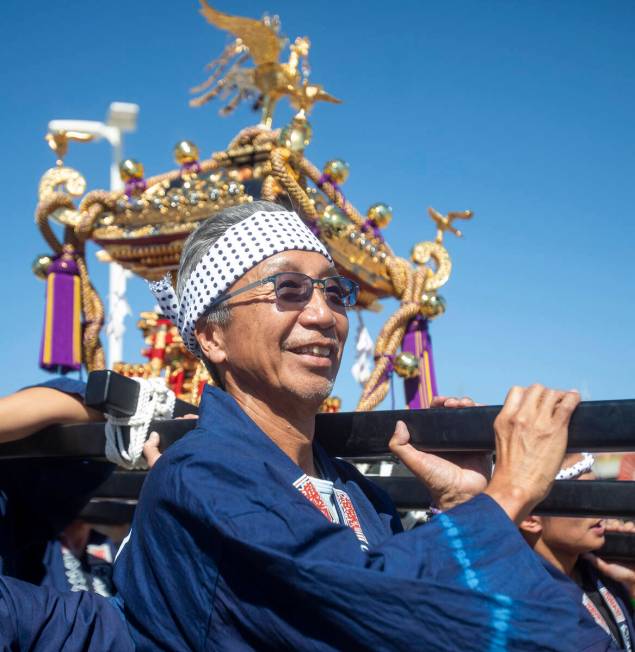 Tak Ishidn, the one who purchased the Mikoshi, helps carry the shrine during the Aki Matsuri Ja ...