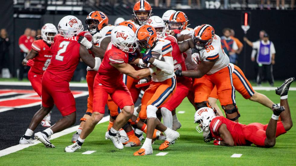 UNLV linebacker Jackson Woodard (7) attempts to tackle Syracuse Orange running back LeQuint All ...