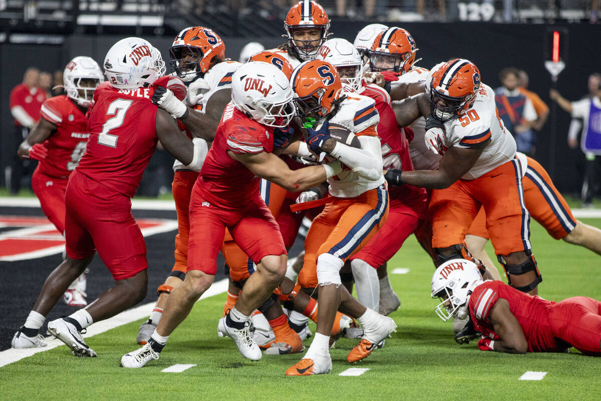 UNLV linebacker Jackson Woodard (7) attempts to tackle Syracuse Orange running back LeQuint All ...