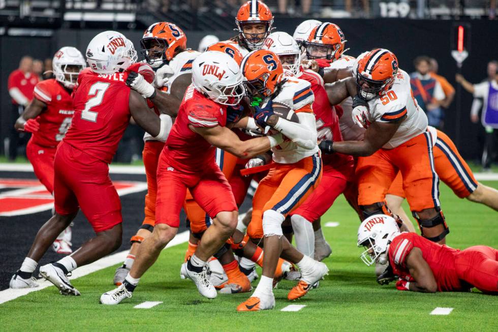 UNLV linebacker Jackson Woodard (7) attempts to tackle Syracuse Orange running back LeQuint All ...