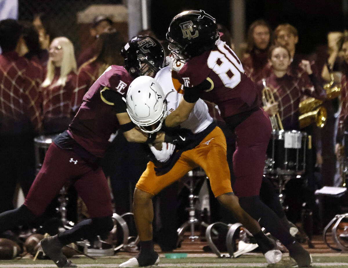 Legacy High's wide receiver Jordan Thompson-Woods (7) is sandwiched between Faith Lutheran's de ...