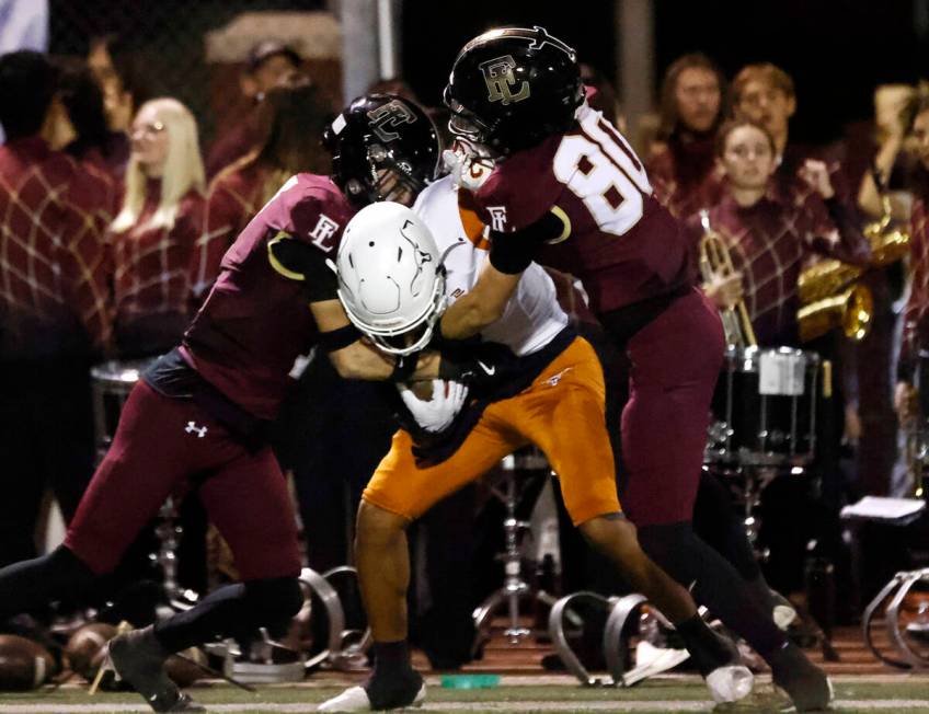 Legacy High's wide receiver Jordan Thompson-Woods (7) is sandwiched between Faith Lutheran's de ...