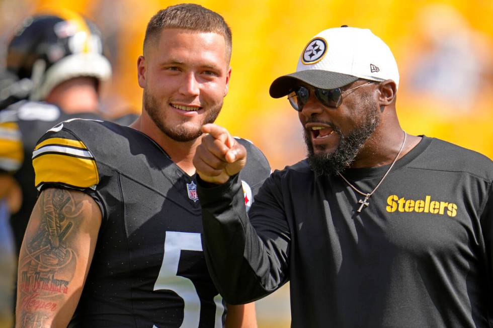 Pittsburgh Steelers linebacker Nick Herbig, left, listens to head coach Mike Tomlin during warm ...