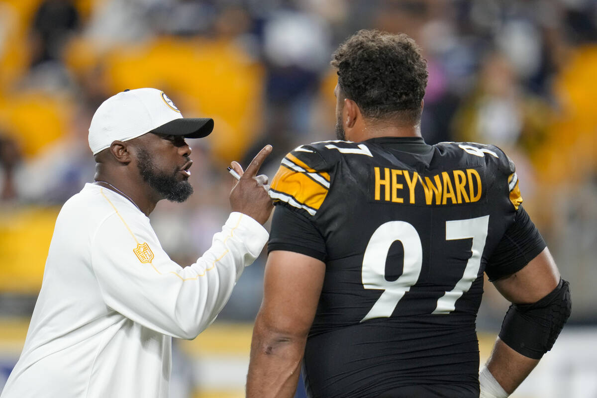 Pittsburgh Steelers head coach Mike Tomlin, left, talks to defensive tackle Cameron Heyward (97 ...