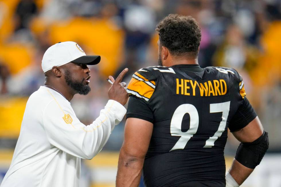 Pittsburgh Steelers head coach Mike Tomlin, left, talks to defensive tackle Cameron Heyward (97 ...