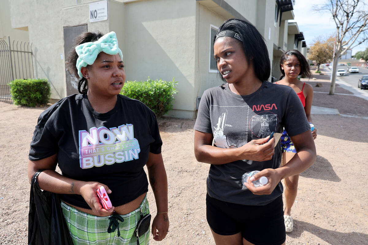 Tyneshia Robinson, 33, left, talks to a neighbor at the intersection of Webb Avenue and Davis P ...