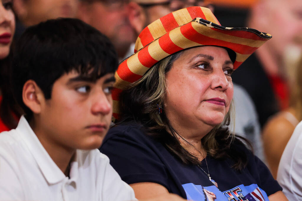 A supporter listens as Republican presidential nominee former President Donald Trump speaks dur ...