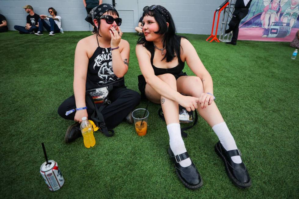 April R., left, and Gaby G., who declined to give their last names, chat on the grass during th ...