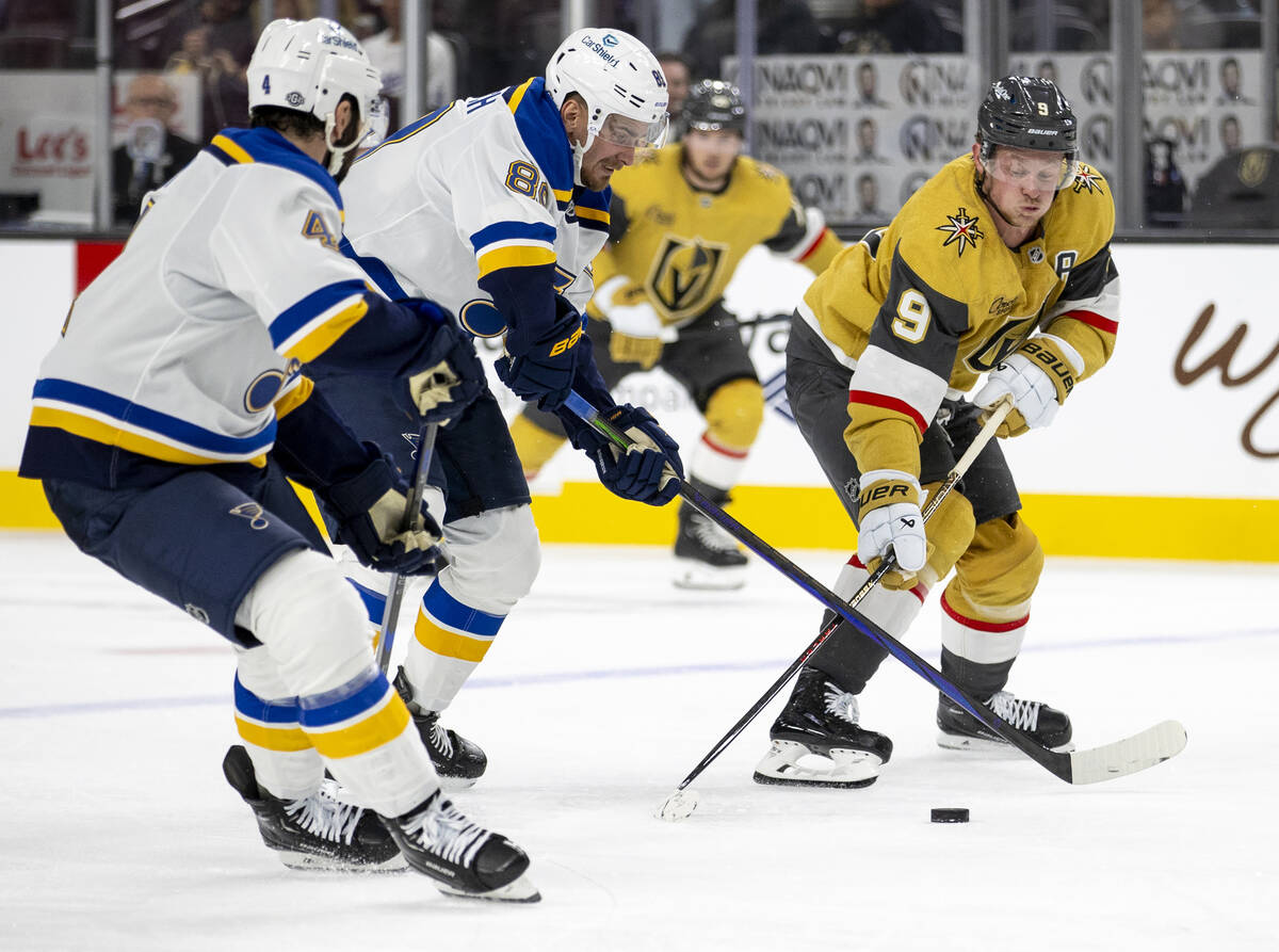 Golden Knights center Jack Eichel (9) attempts to control the puck during the NHL hockey game a ...