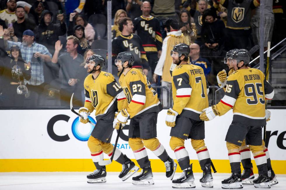 Golden Knights center Nicolas Roy (10) leads his teammates to celebrate with the bench after sc ...