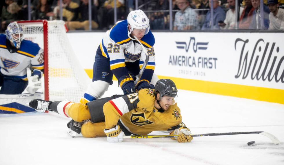 St. Louis Blues defenseman Ryan Suter (22) pushes Golden Knights center Brett Howden (21) while ...