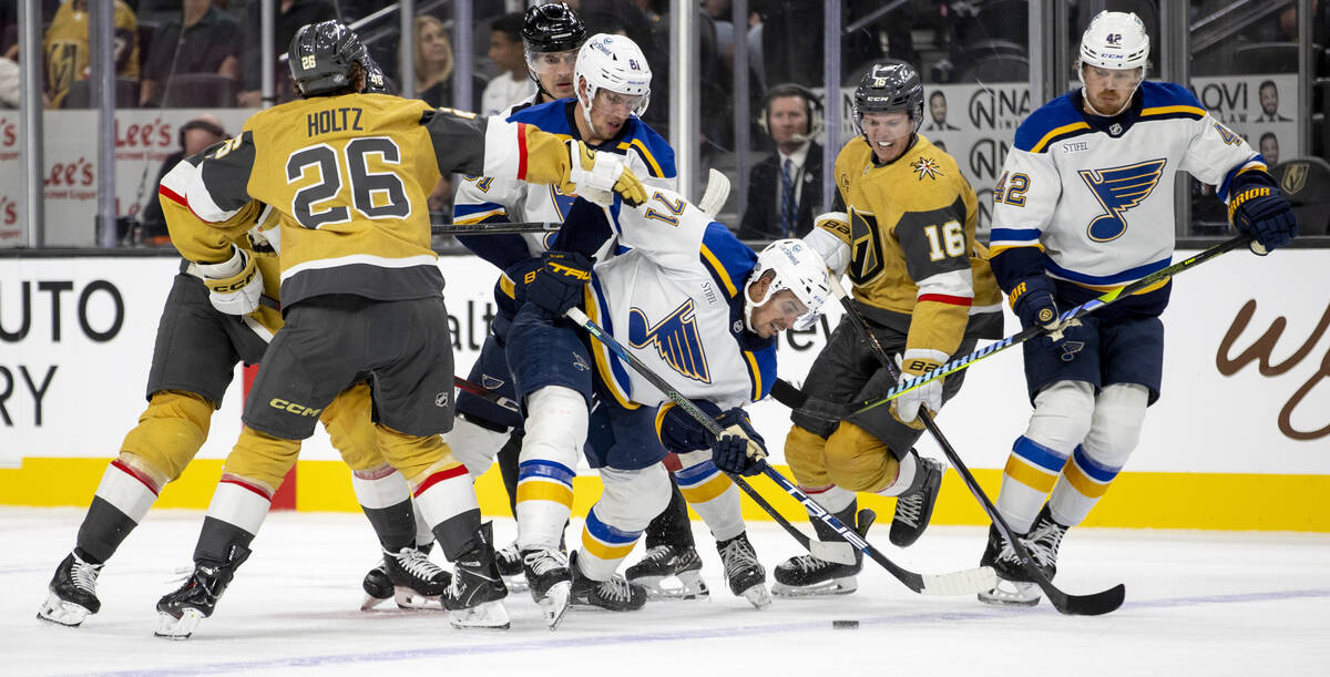 Golden Knights and St. Louis Blues players compete for the puck during the NHL hockey game at T ...