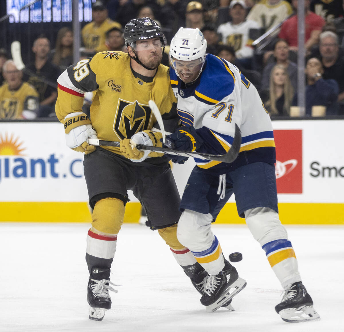 Golden Knights center Ivan Barbashev (49) and St. Louis Blues right wing Mathieu Joseph (71) ru ...