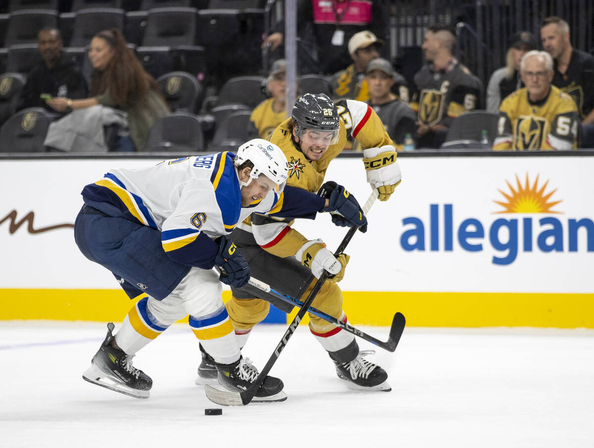 Golden Knights right wing Alexander Holtz (26) and St. Louis Blues defenseman Philip Broberg (6 ...