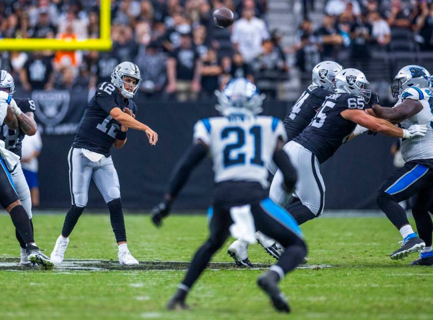 Raiders quarterback Aidan O'Connell (12) throws a late pass against the Carolina Panthers durin ...