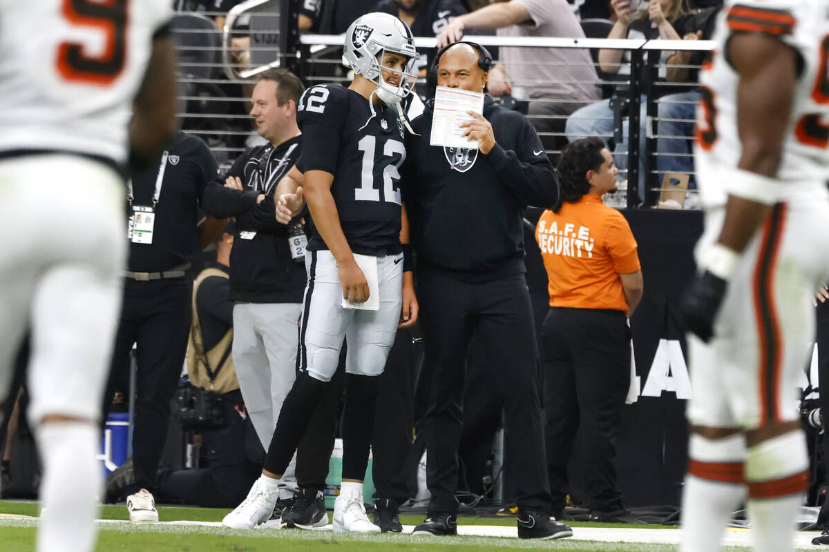 Raiders head coach Antonio Pierce speaks to quarterback Aidan O'Connell (12) on the sidelines d ...