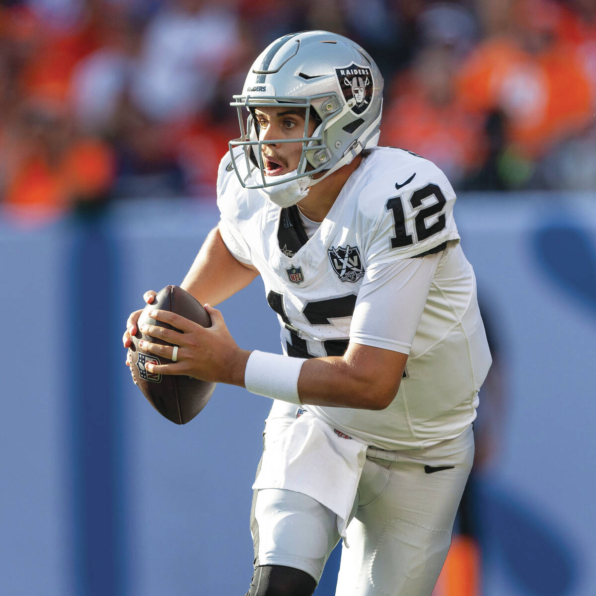 Raiders quarterback Aidan O'Connell (12) rushes with the football during the second half of an ...