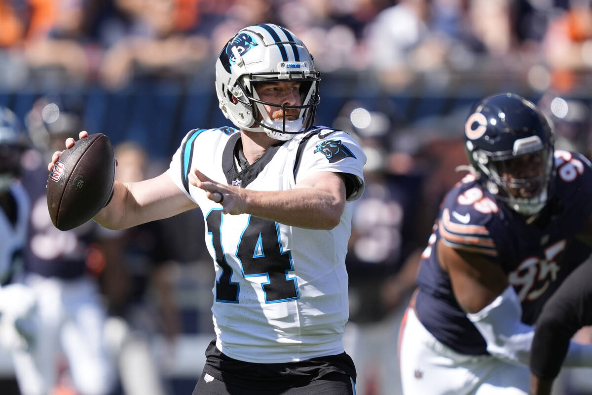 Carolina Panthers quarterback Andy Dalton looks to pass during an NFL football game against the ...