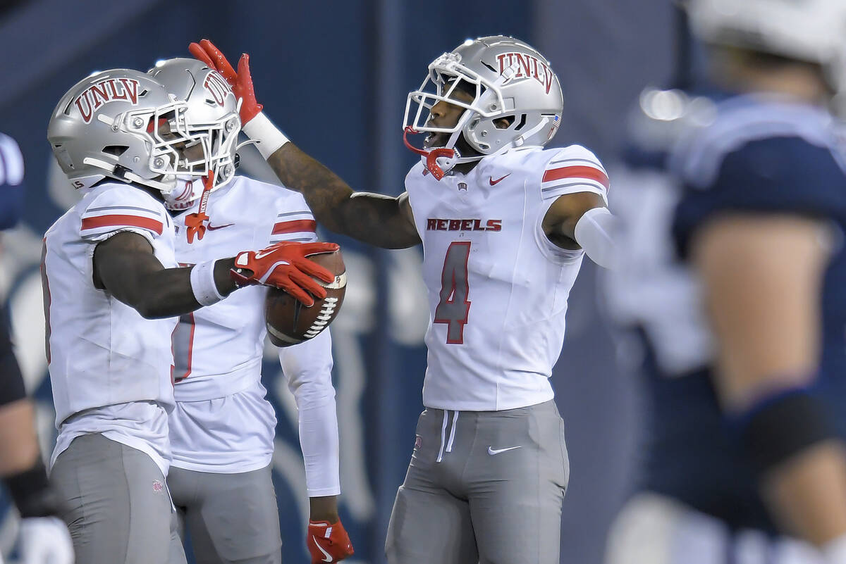 UNLV defensive back Jett Elad, left, celebrates with defensive back Malik Chavis (4) after inte ...