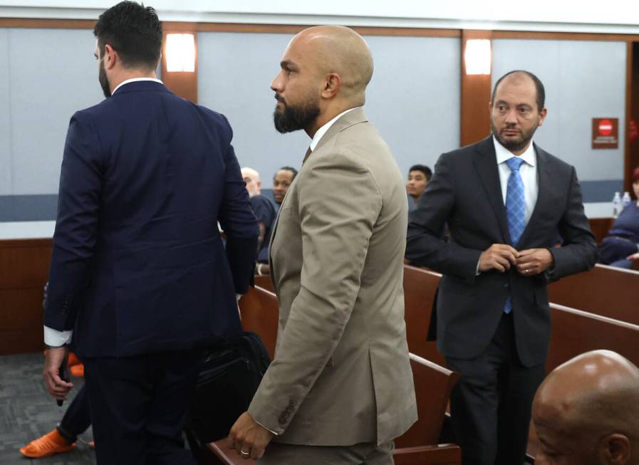 Sgt. Kevin Menon, center, who is charged with multiple counts of oppression under the color of ...