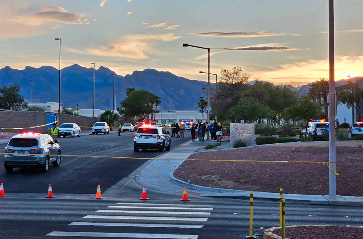 Metro police at the scene of a triple shooting in the 7300 block of Prairie Falcon Road on Satu ...