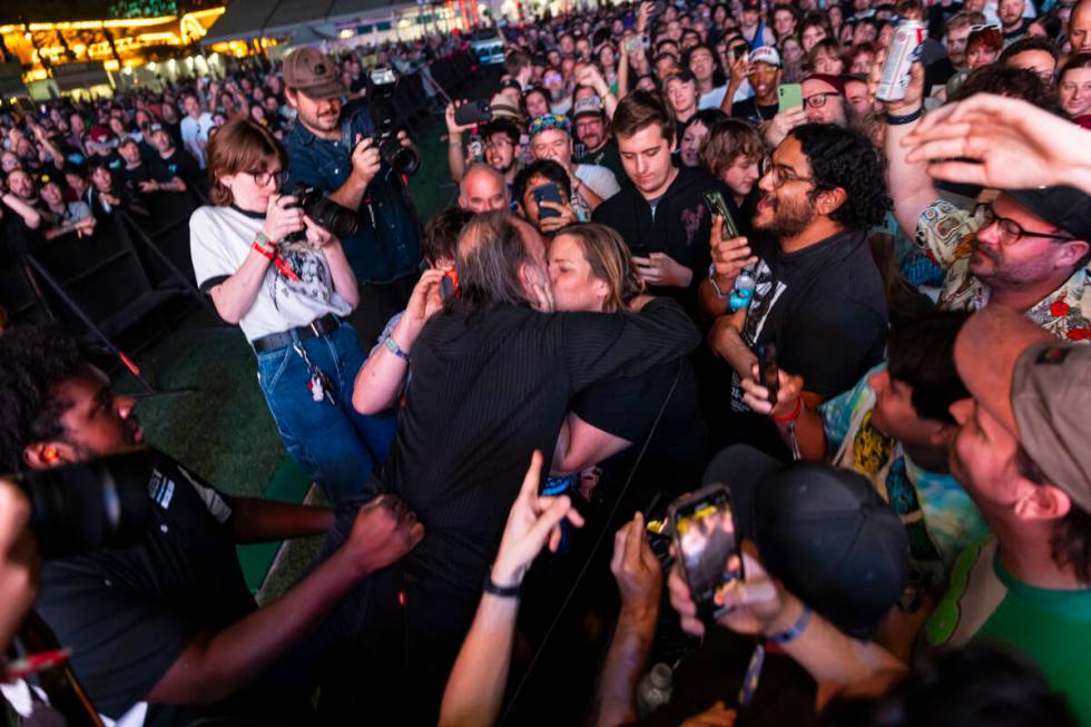 An audience member pulls David Yow of The Jesus Lizard in for a kiss during the final night of ...