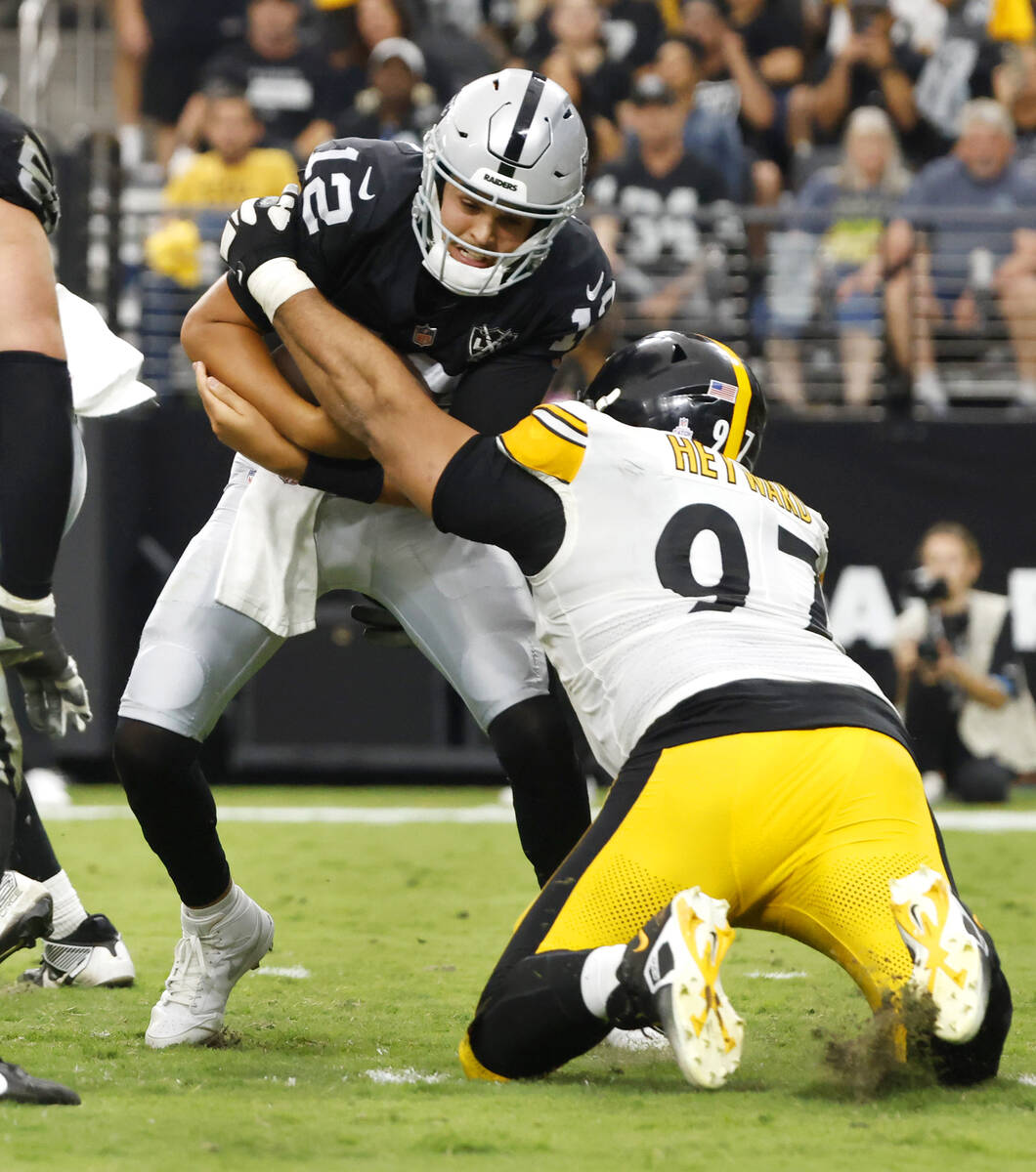 Raiders quarterback Aidan O'Connell (12) is sacked by Pittsburgh Steelers defensive tackle Came ...