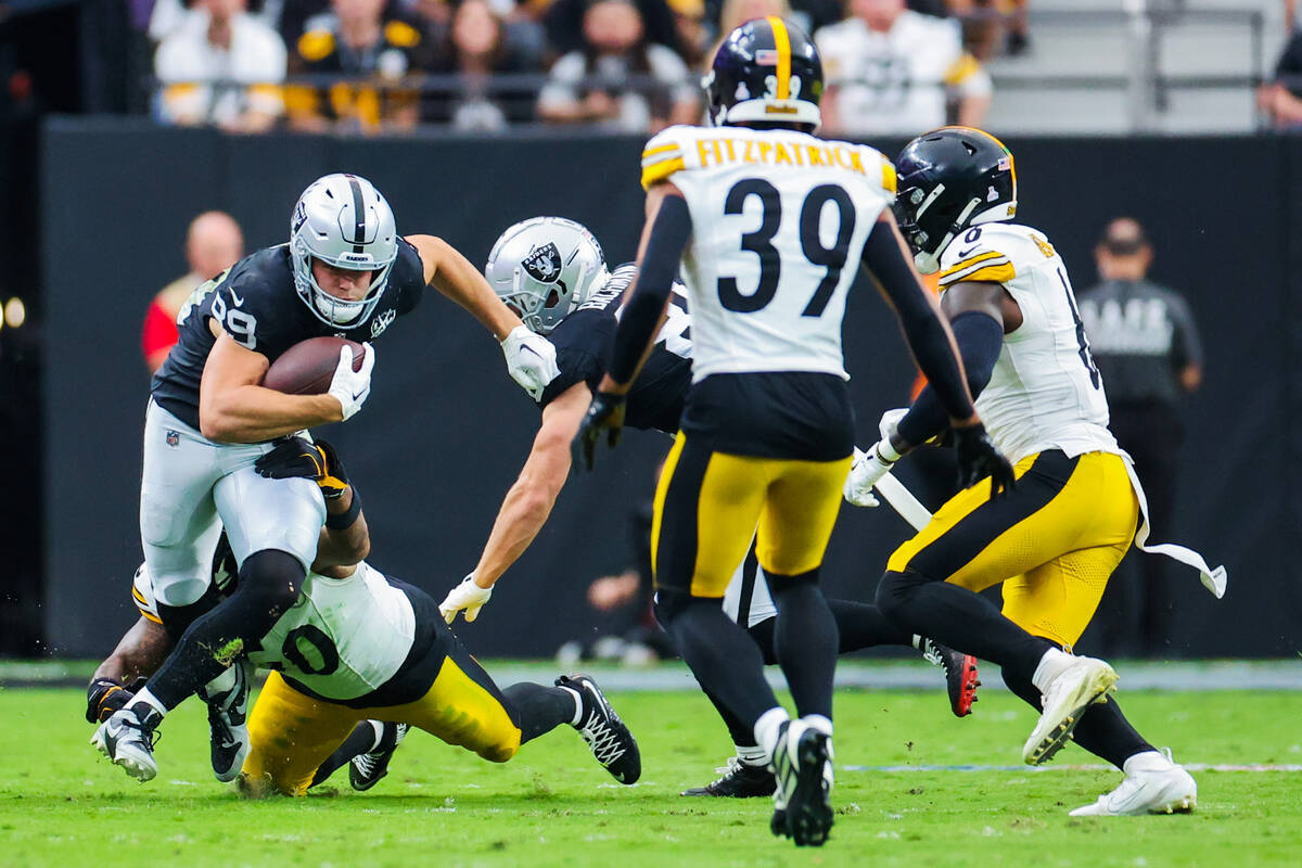 Raiders tight end Brock Bowers (89) carries the ball during the first half of an NFL football g ...