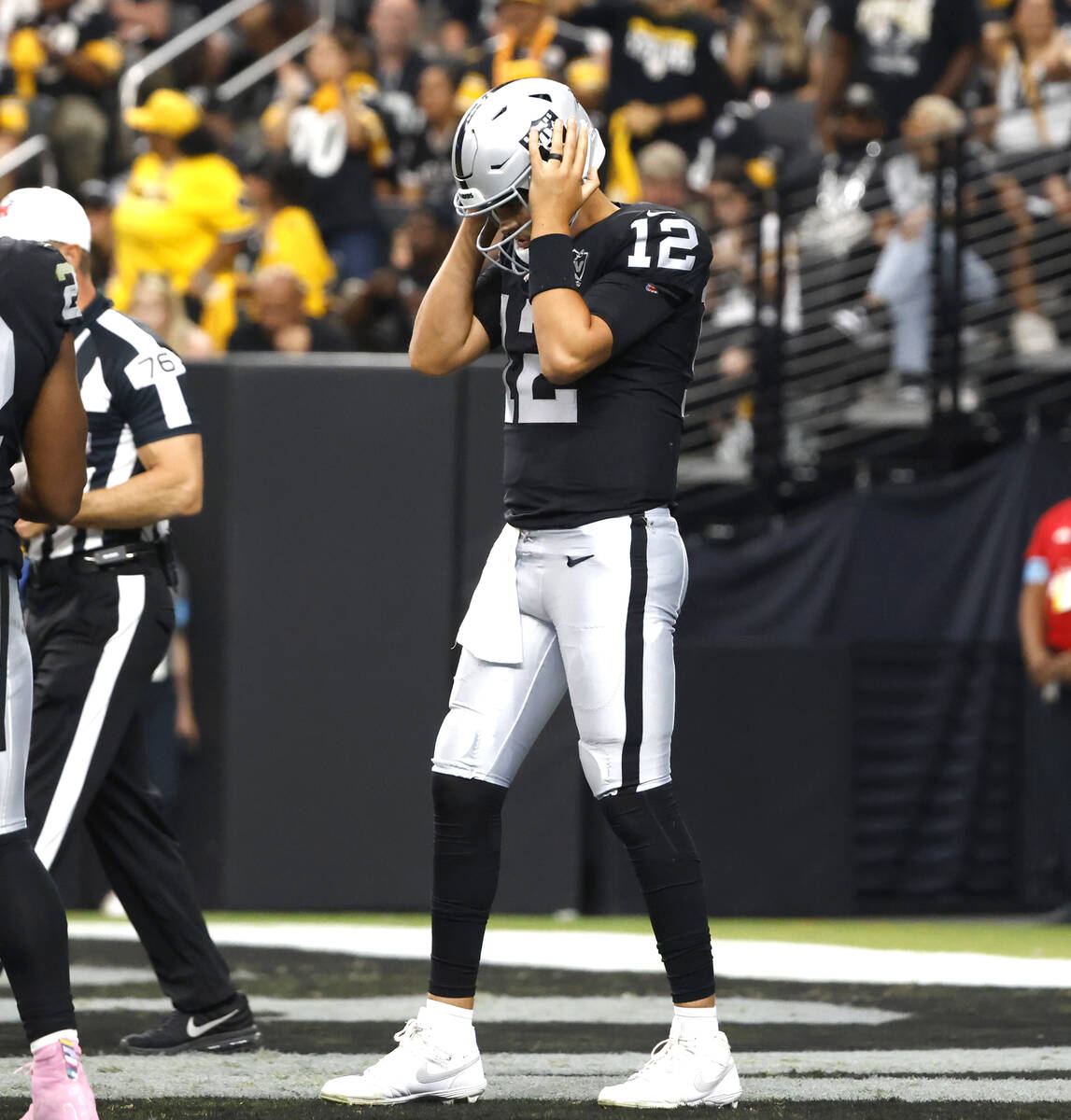 Raiders quarterback Aidan O'Connell (12) reacts after being sacked by Pittsburgh Steelers defen ...