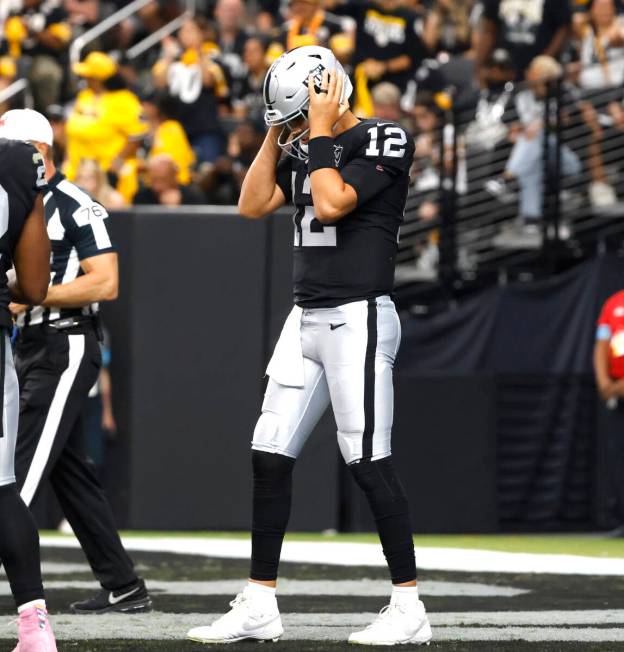 Raiders quarterback Aidan O'Connell (12) reacts after being sacked by Pittsburgh Steelers defen ...