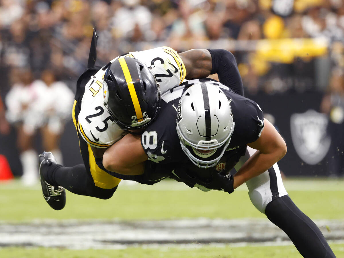 Raiders tight end Harrison Bryant (84) is taken down by Pittsburgh Steelers safety DeShon Ellio ...