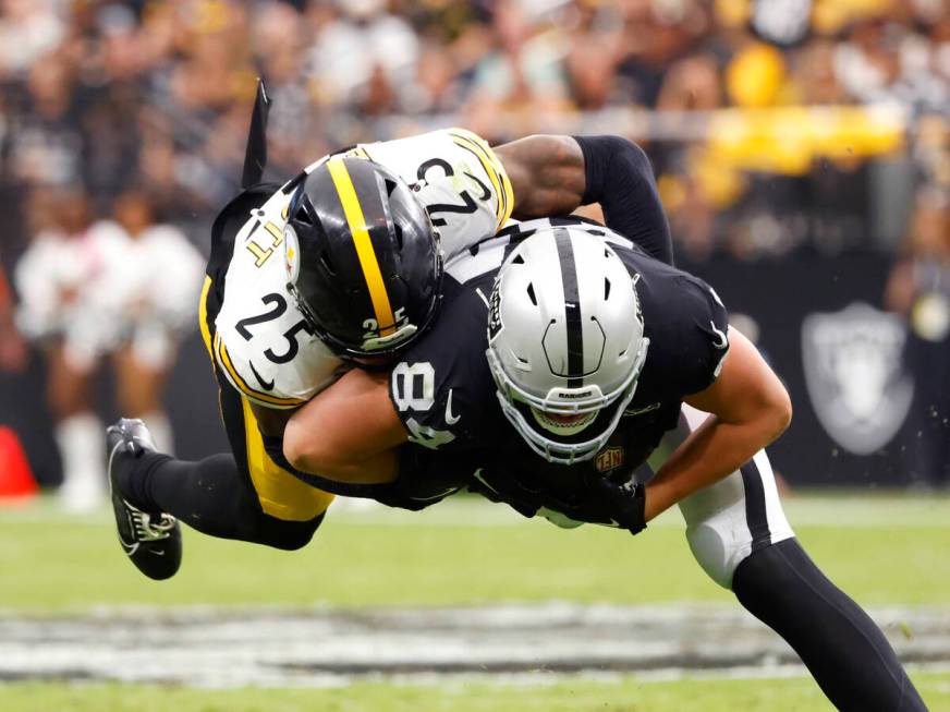 Raiders tight end Harrison Bryant (84) is taken down by Pittsburgh Steelers safety DeShon Ellio ...