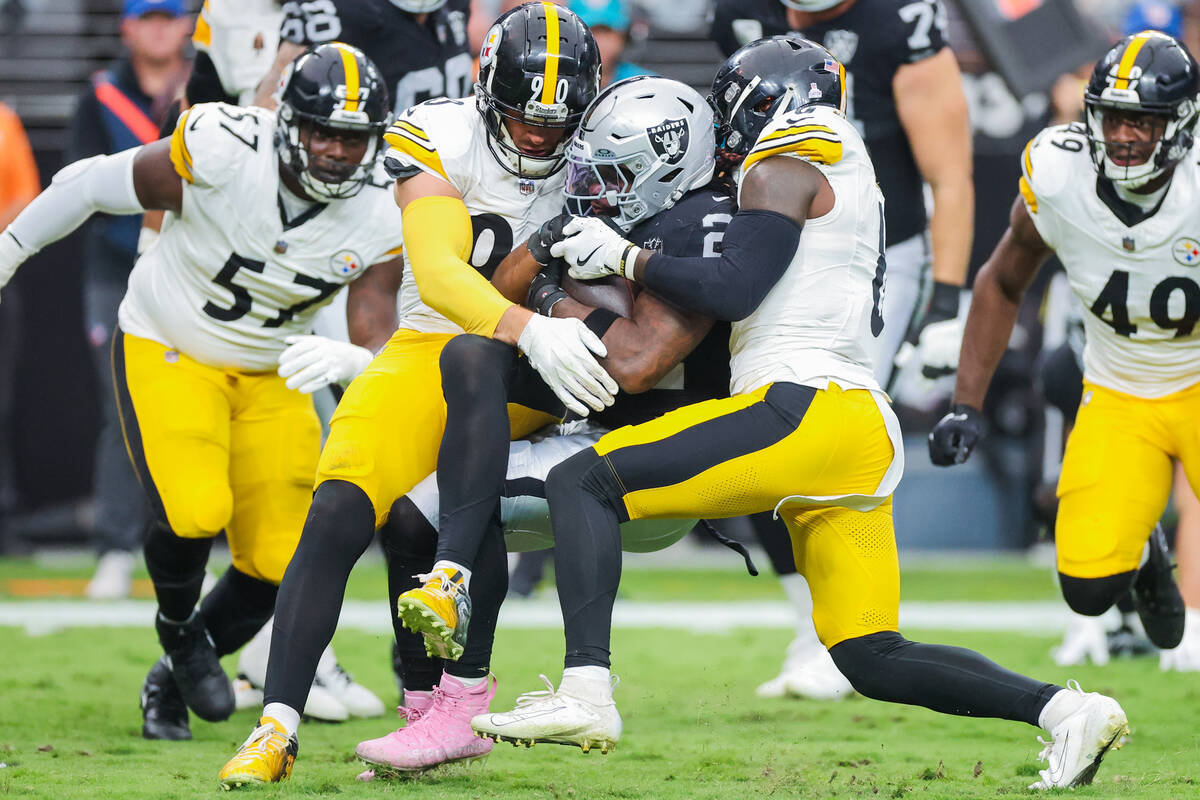 Raiders running back Alexander Mattison (22) carries the ball as Pittsburgh Steelers linebacker ...