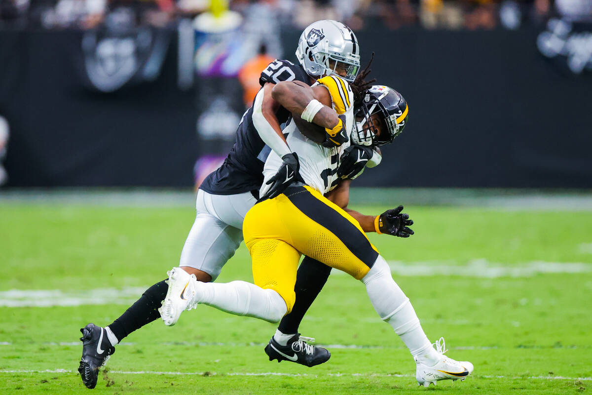 Raiders safety Isaiah Pola-Mao (20) closes in on Pittsburgh Steelers running back Najee Harris ...