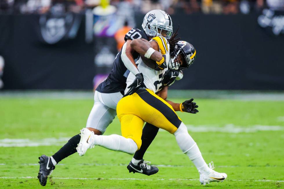 Raiders safety Isaiah Pola-Mao (20) closes in on Pittsburgh Steelers running back Najee Harris ...