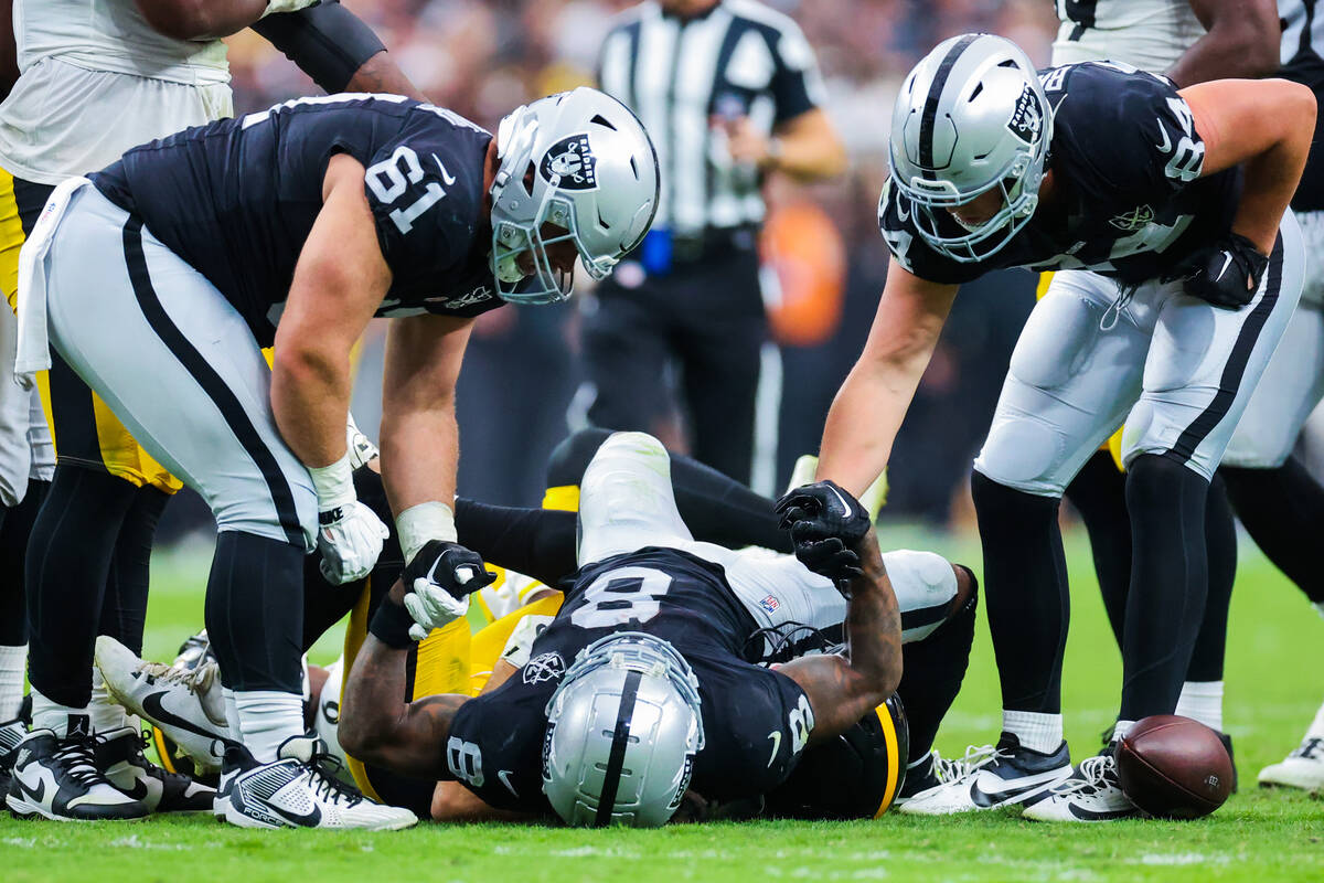 Raiders running back Ameer Abdullah (8) gets help getting up from teammates Jordan Meredith (61 ...