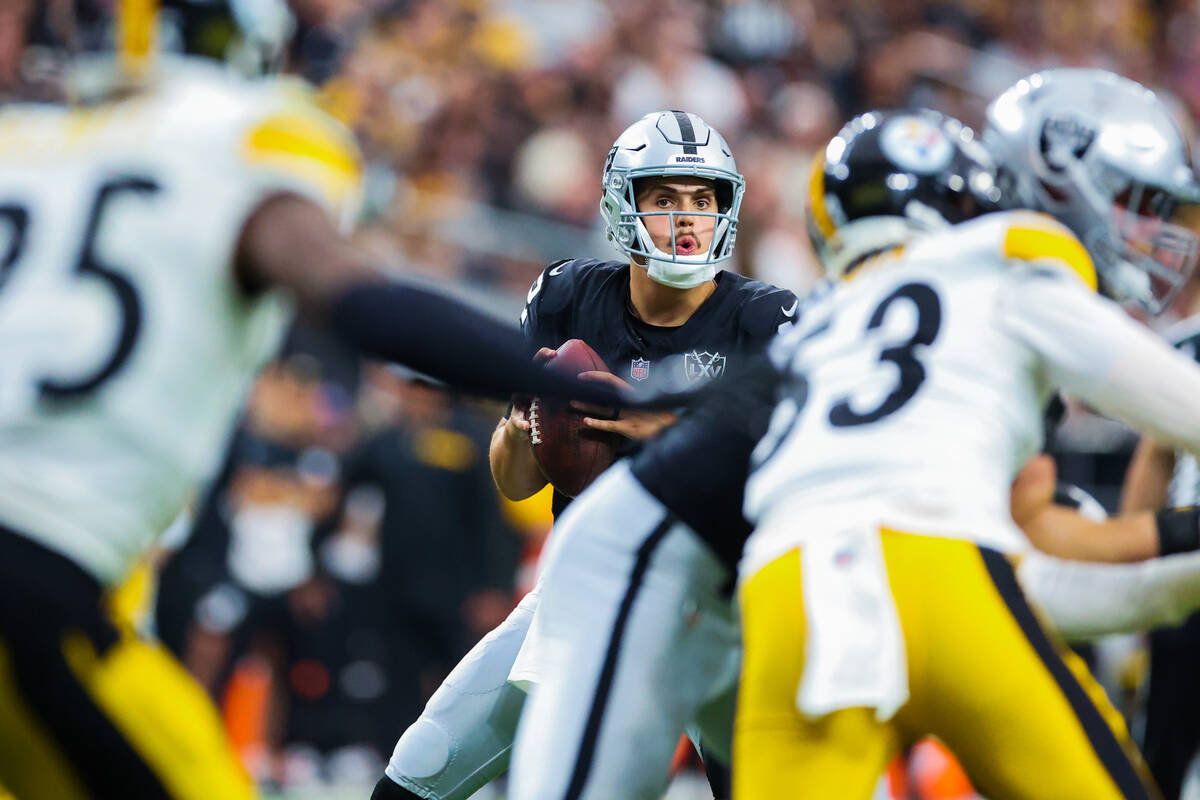 Raiders quarterback Aidan O'Connell (12) looks to throw the ball during the second half of an N ...