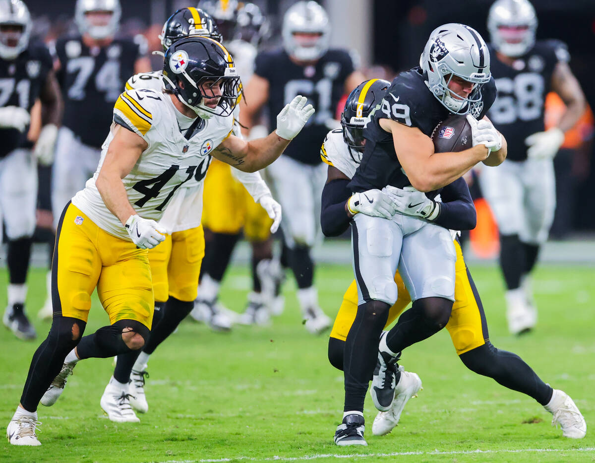 Raiders tight end Brock Bowers (89) powers the ball through Pittsburgh Steelers defense during ...