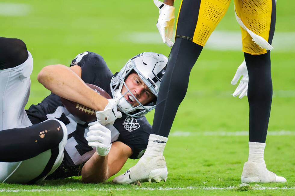 Raiders tight end Brock Bowers (89) keeps the ballin his grip after being brought to the turf d ...