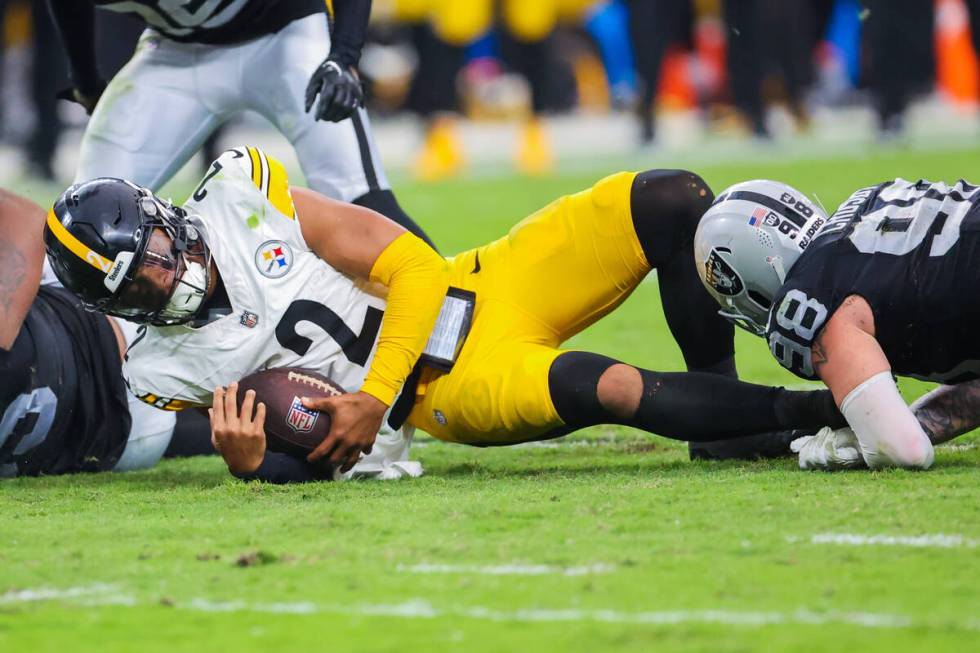 Pittsburgh Steelers quarterback Justin Fields (2) goes down with the ball during the second hal ...