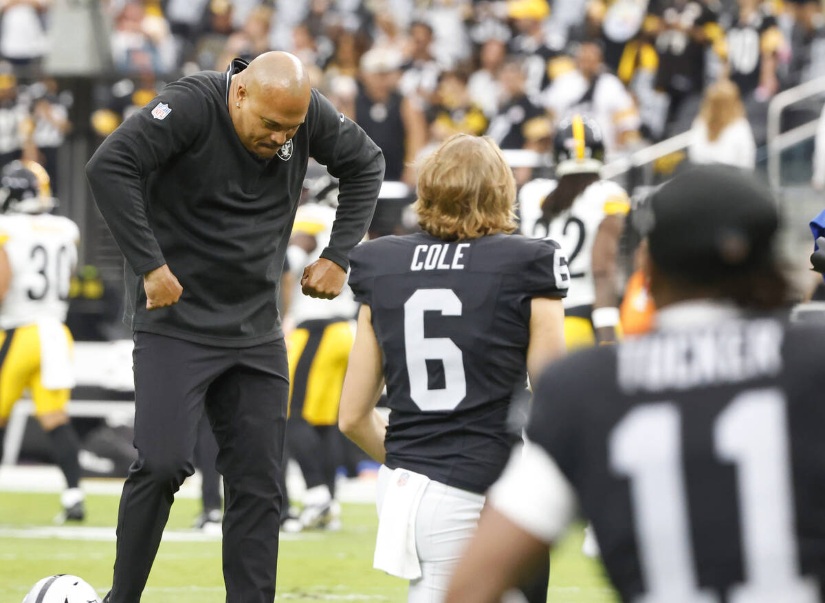 Raiders head coach Antonio Pierce reacts as punter AJ Cole (6) looks on during team's warm up b ...