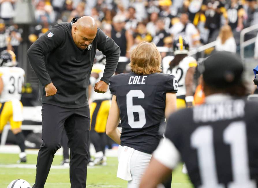 Raiders head coach Antonio Pierce reacts as punter AJ Cole (6) looks on during team's warm up b ...