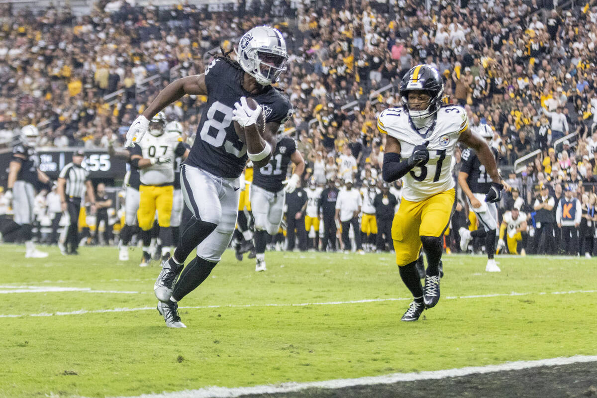 Raiders wide receiver Kristian Wilkerson (83) heads to the end zone with Pittsburgh Steelers co ...