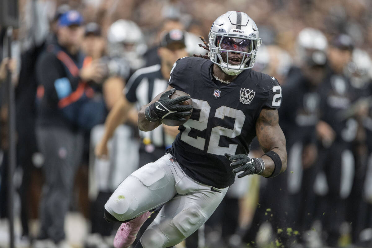 Vegas Raiders running back Alexander Mattison (22) runs with the football during the first half ...