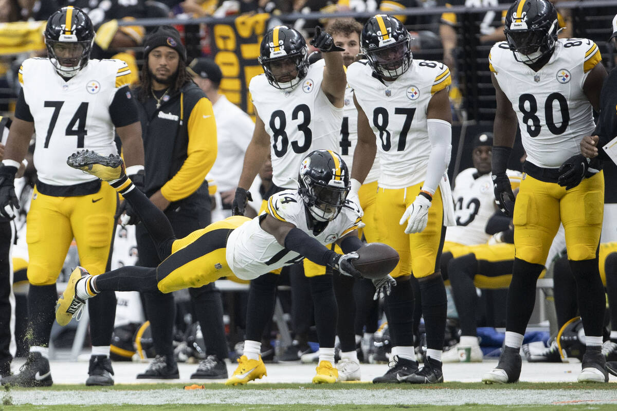 Pittsburgh Steelers wide receiver George Pickens (14) lays out to extend himself in an attempt ...