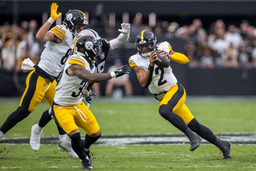 Pittsburgh Steelers quarterback Justin Fields (2) rushes past Vegas Raiders defensive end Maxx ...