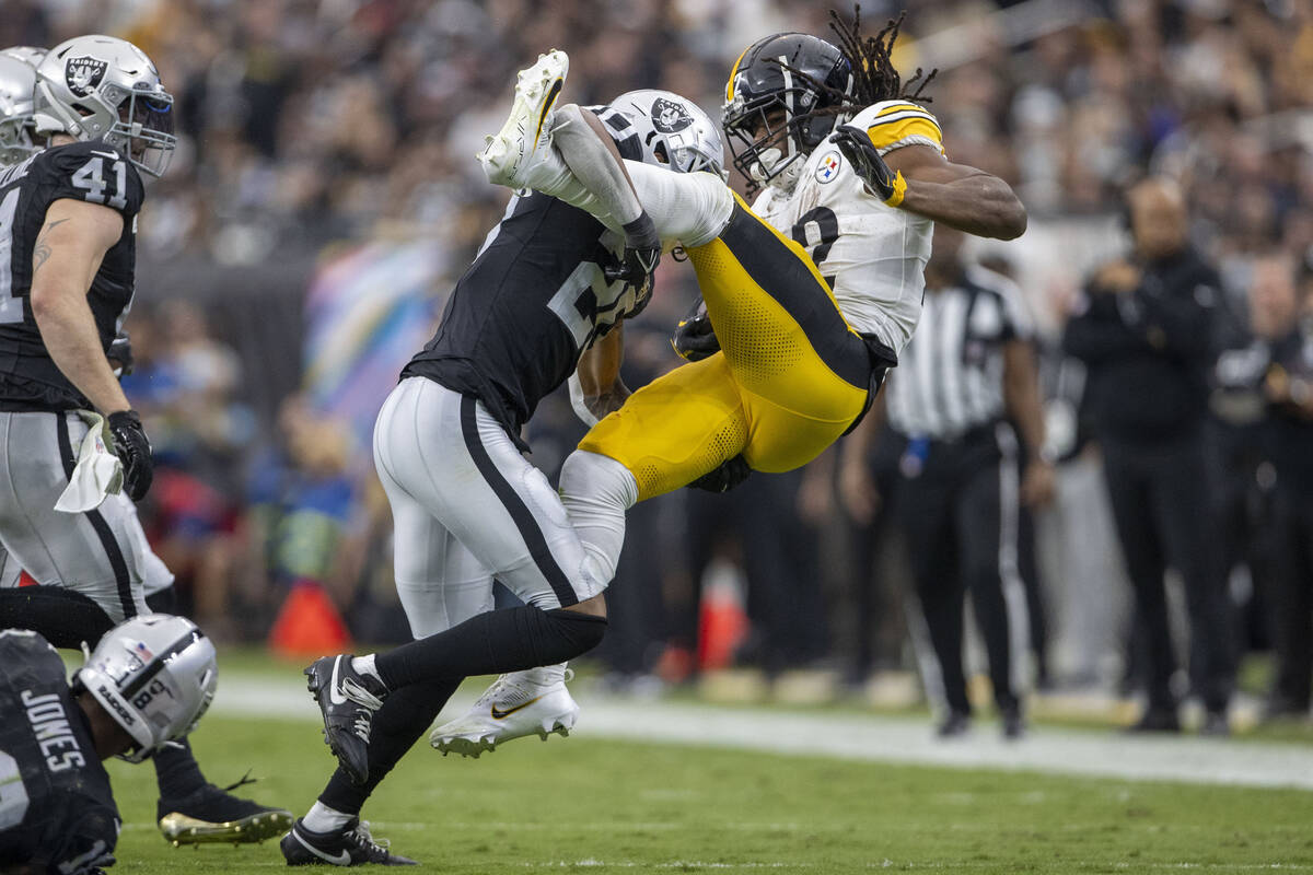 Raiders safety Isaiah Pola-Mao (20) tackles Pittsburgh Steelers running back Najee Harris (22) ...