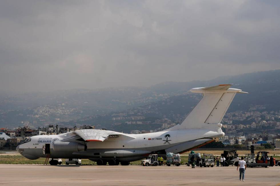 Workers unload Saudi medical aid boxes arriving at Beirut International airport, Lebanon, Sunda ...