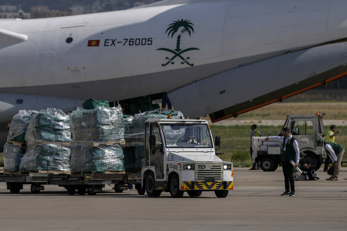 Workers unload Saudi medical aid boxes arriving at Beirut International airport, Lebanon, Sunda ...