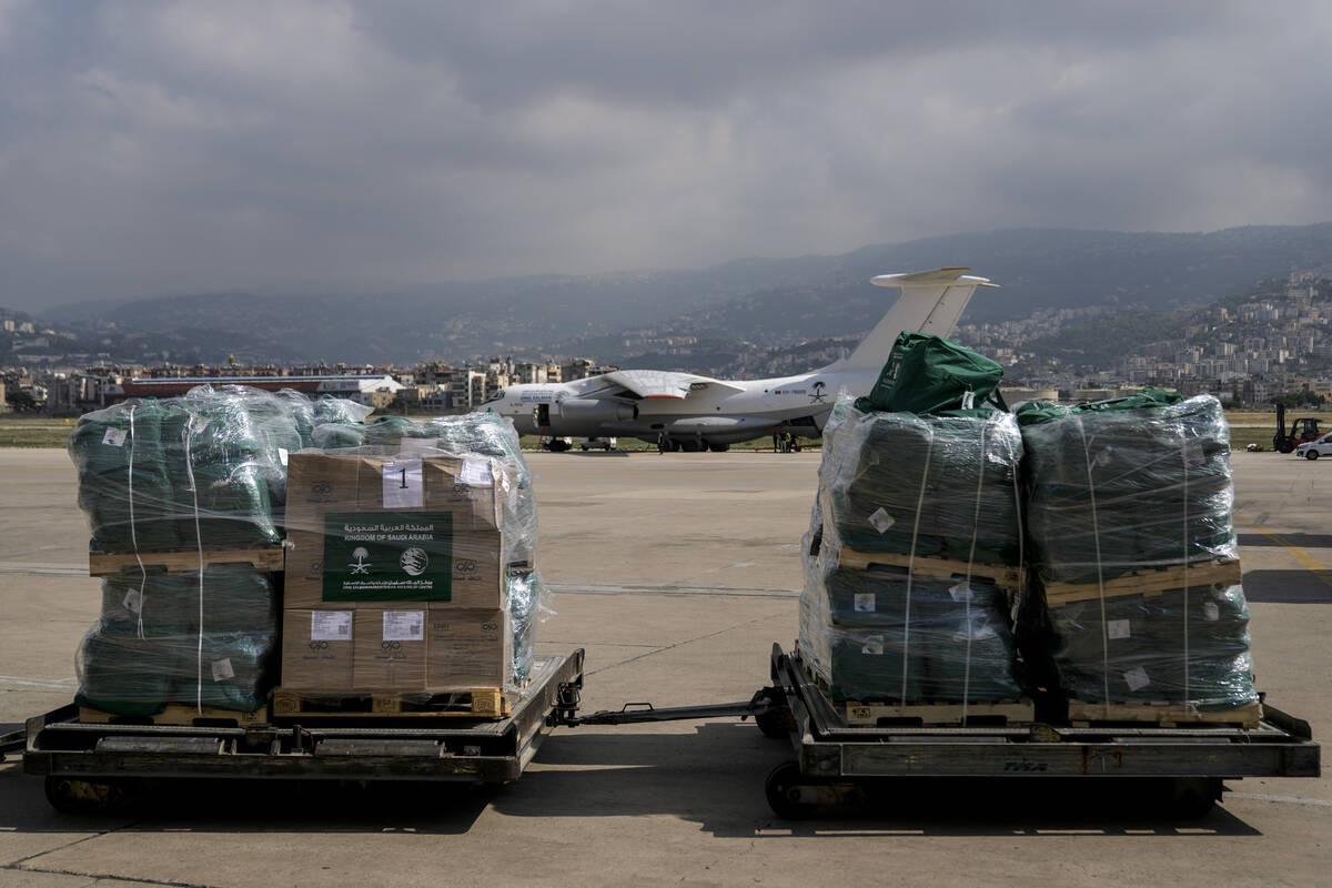 Workers unload Saudi medical aid boxes arriving at Beirut International airport, Lebanon, Sunda ...